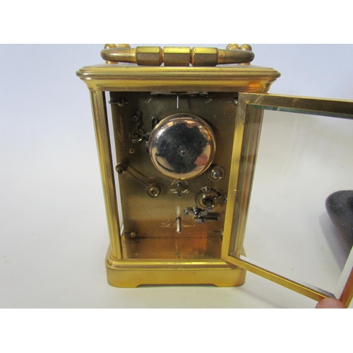 1375 - A cased brass carriage clock, named G.G. Denham, Leeds, with glass dome