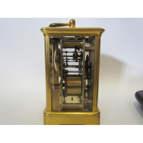 1375 - A cased brass carriage clock, named G.G. Denham, Leeds, with glass dome