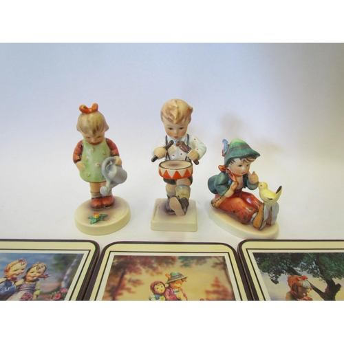 1377 - Three boxed Hummel Goebel figures and a boxed set of six hummel coasters