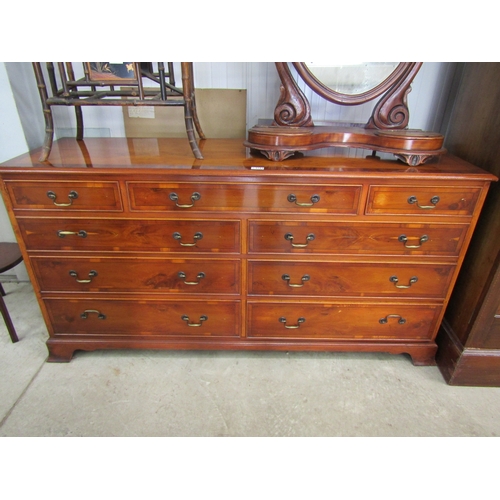 2163 - A yew wood chest of three over six drawers by Bradley