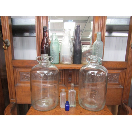 2170 - Two Glass Demijohns and 9 vintage glass bottles