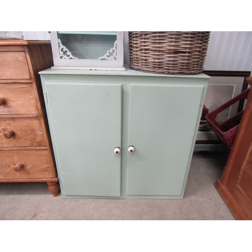 2214 - A green painted two door cupboard           (E) £15-30