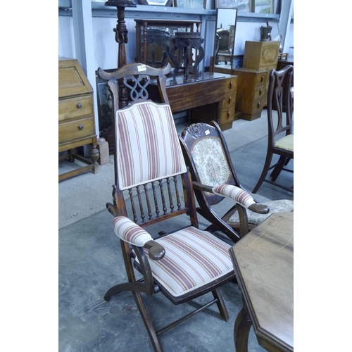 2144 - An Edwardian folding campaign chair, upholstered seat, back and arms, spindle rail