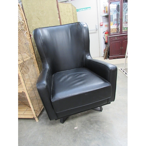 2259 - A large black leather swivel chair