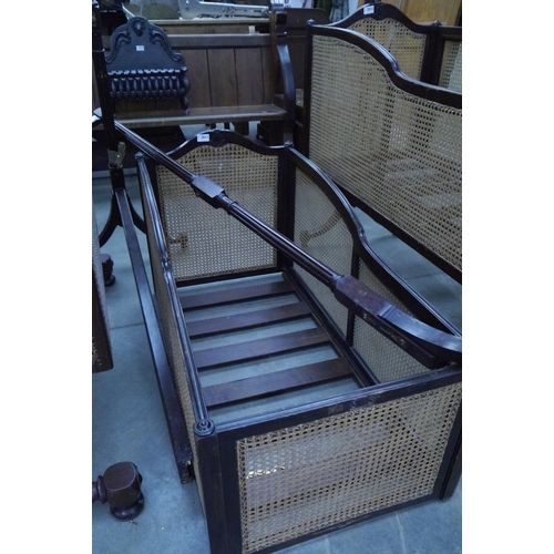 2011 - An early 20th Century mahogany swing cot with cane panels, stand a/f       (R) £50