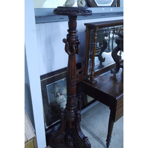 2081 - A heavily carved hardwood torchere stand