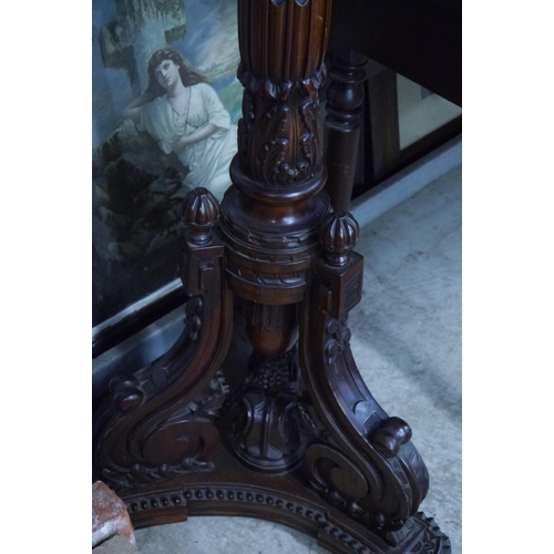 2081 - A heavily carved hardwood torchere stand