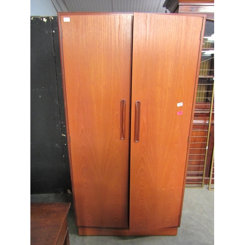 2245 - A G-plan teak two door wardrobe  with fitted shelf and drawer interior