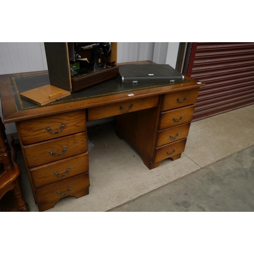 2301 - A modern oak twin pedestal desk of nine drawers with leather insert top a/f