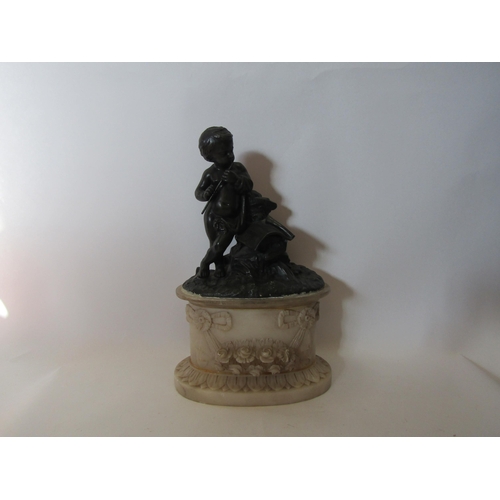 1513 - A bronze effect statue of a boy playing pipe on alabaster base, 32cm tall