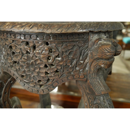 2086 - An Anglo Indian heavily carved hardwood jardinere stand