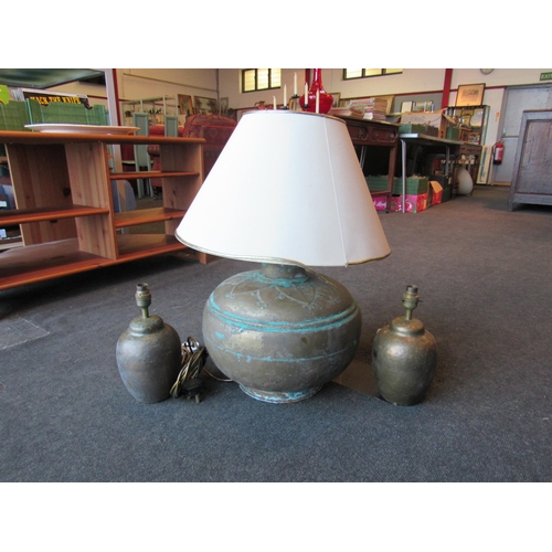 1003 - A large Eastern brass lamp with shade and a pair of brass table lamps (3)