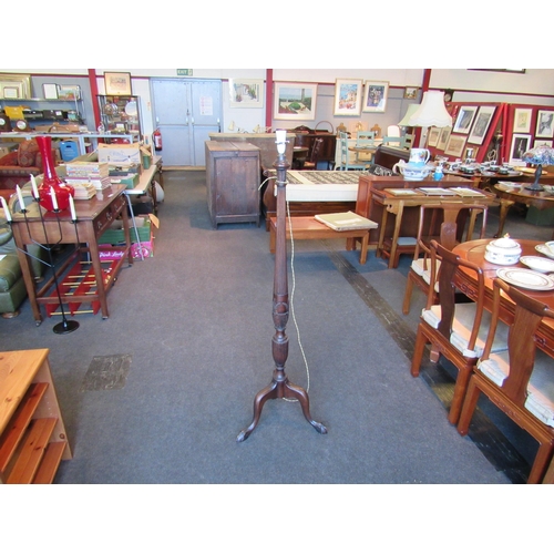 1112 - A mahogany standard lamp, reeded column raised on three ball and claw feet