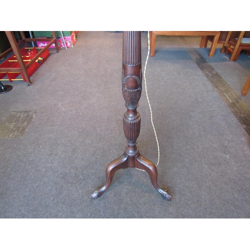 1112 - A mahogany standard lamp, reeded column raised on three ball and claw feet