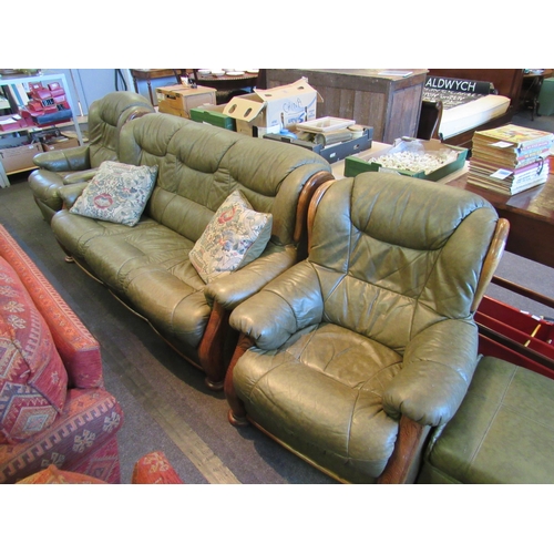 1163 - A four piece leather and oak framed suite comprising of a three seater sofa, armchair, reclining arm... 