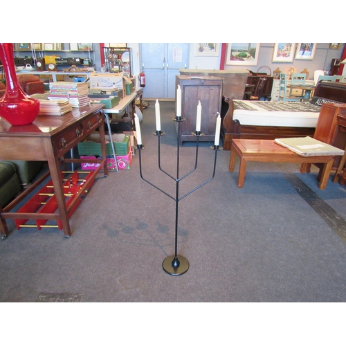 1168 - A ruby glass vase 51cm tall, together with a floor standing five branch candle holder 97cm tall