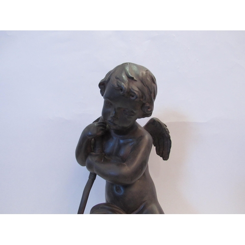 1223 - A bronze effect resin cherubic sculpture, 46cm tall