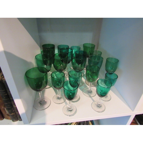 1394 - Twenty Victorian and later green glasses with clear stems to foot, varying sizes