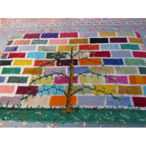 8183 - A shag pile style small rug with a bright coloured brick pattern with central tree design, 66cm x 10... 