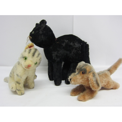 8298 - Three straw filled mohair animals in the manner of Steiff, comprising black cat, cream striped cat (... 