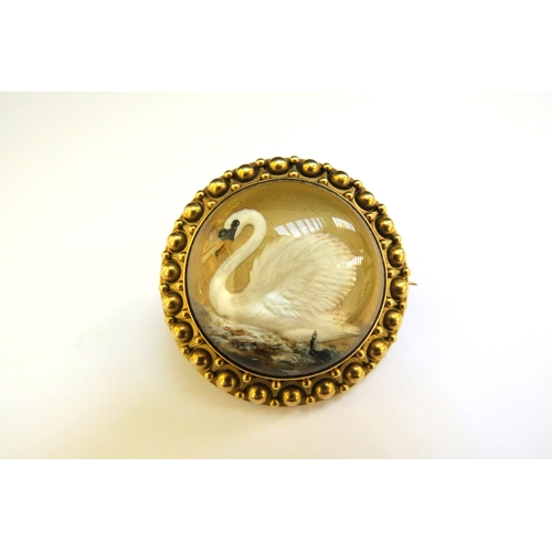 9256 - A 19th Century reverse painted domed glass/crystal brooch the image as a swan, 37mm diameter approx