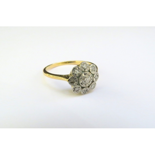 9266 - An 18ct gold platinum set diamond daisy ring in illusion settings. Size P/Q, 3g