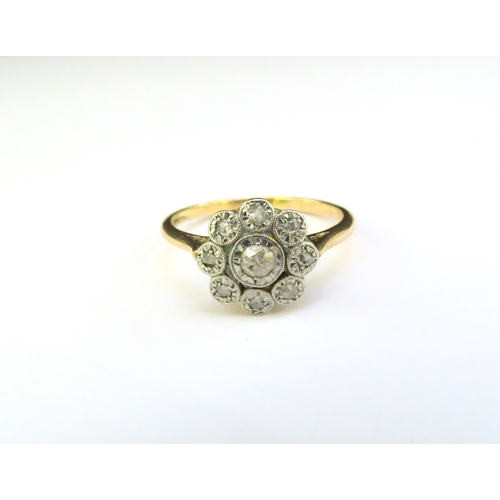 9266 - An 18ct gold platinum set diamond daisy ring in illusion settings. Size P/Q, 3g