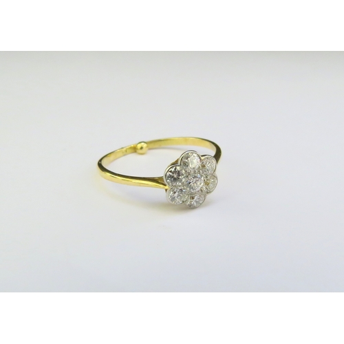 9176 - An 18ct gold diamond daisy ring. Size N with spacer, 1.9g