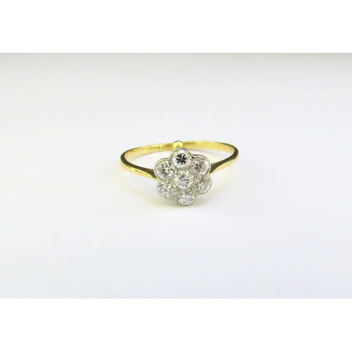 9176 - An 18ct gold diamond daisy ring. Size N with spacer, 1.9g