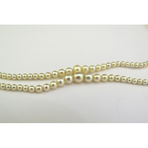 9143 - A double row of fine graduated pearls with a diamond cluster fastening, 46cm longest row