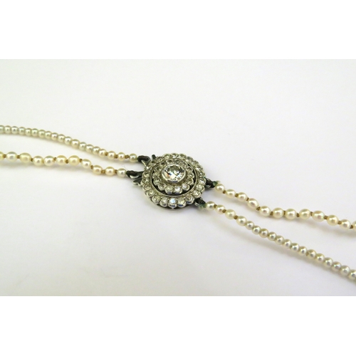 9143 - A double row of fine graduated pearls with a diamond cluster fastening, 46cm longest row