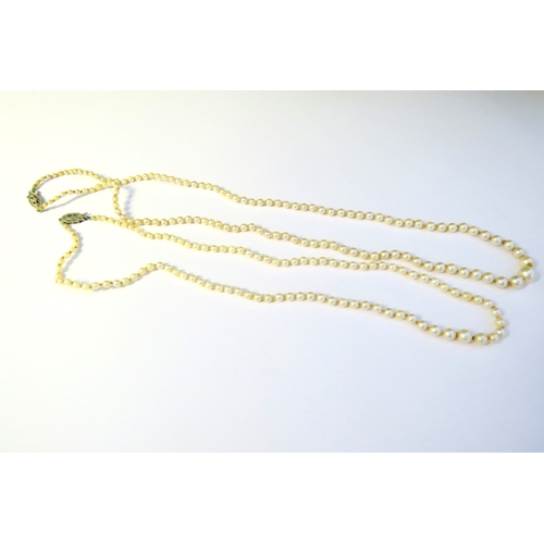 9231 - Two single strand pearl necklaces each with a diamond set clasp