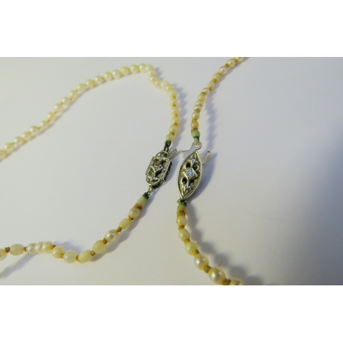 9231 - Two single strand pearl necklaces each with a diamond set clasp