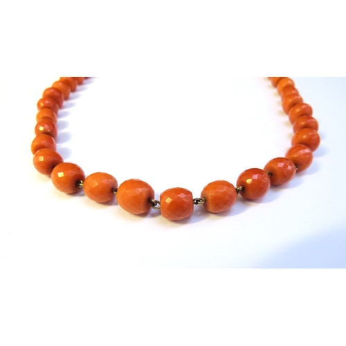 9196 - A coral necklace with facet cut beads, 46cm long