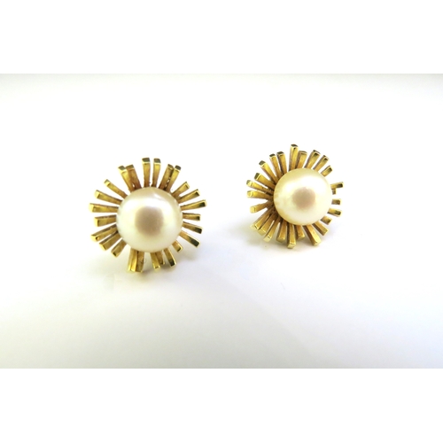 9183 - A pair of 14ct gold earrings with a pearl centre, 7.2g