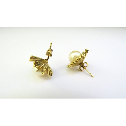 9183 - A pair of 14ct gold earrings with a pearl centre, 7.2g