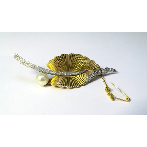 9160 - An 18ct gold and platinum brooch as a stylised leaf, the textured gold leaf with a platinum set diam... 