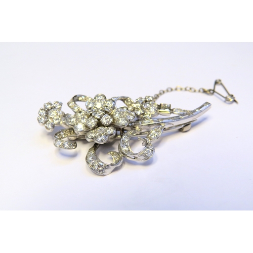 9151 - A diamond encrusted brooch as a floral spray, 3ct plus of brilliant and baguette cut diamonds, 5cm x... 