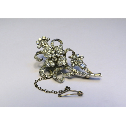 9151 - A diamond encrusted brooch as a floral spray, 3ct plus of brilliant and baguette cut diamonds, 5cm x... 