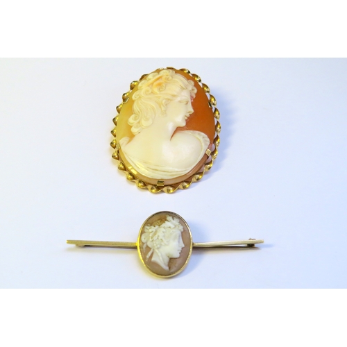 9158 - An unmarked gold cameo brooch and a cameo bar brooch