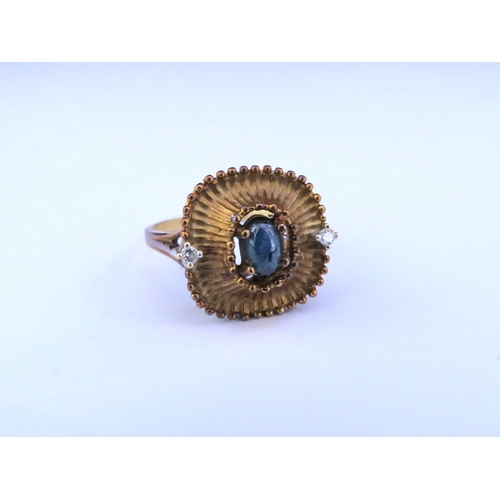 9316 - A cabochon sapphire and diamond ring, shank stamped 750. Size P/Q, 5.3g