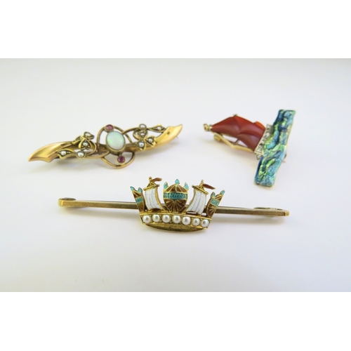 9229 - Three gold brooches, one with an entremblant sail boat on enamelled sea with diamond crest, enamel a... 