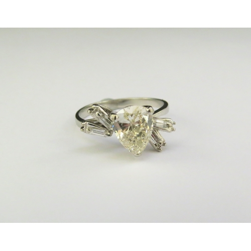 9137 - A Deco diamond ring with central pear shaped diamond 1.75ct approx with baguette cut diamond shoulde... 