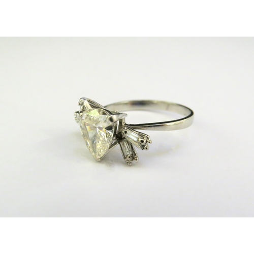 9137 - A Deco diamond ring with central pear shaped diamond 1.75ct approx with baguette cut diamond shoulde... 