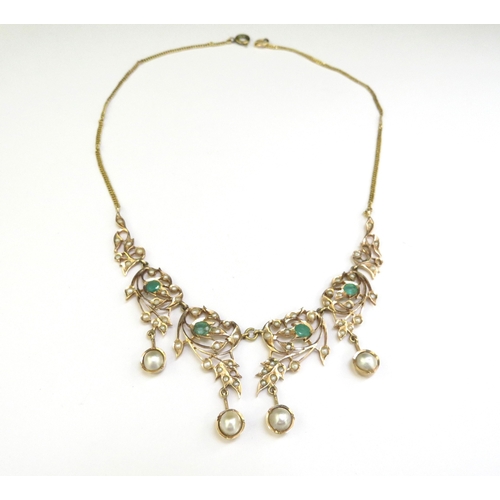 9187 - An emerald and seed pearl studded necklet the central four panels hung with a pearl droplet, on late... 