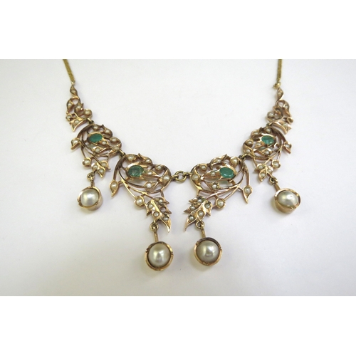 9187 - An emerald and seed pearl studded necklet the central four panels hung with a pearl droplet, on late... 