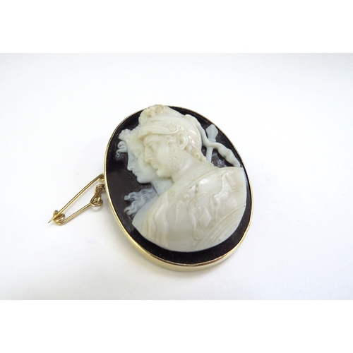 9064 - A cameo brooch depicting a Roman soldier and female side profile carved from a white/cream stone pos... 