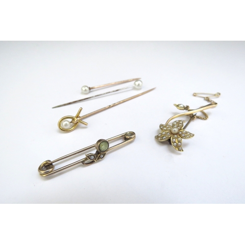 9246 - Two gold brooches one as a seed pearl set flower and a gold stick pin, unmarked, 7.6g