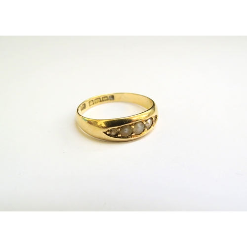 9157 - An 18ct gold ring set with seed pearls, one missing, 2.9g