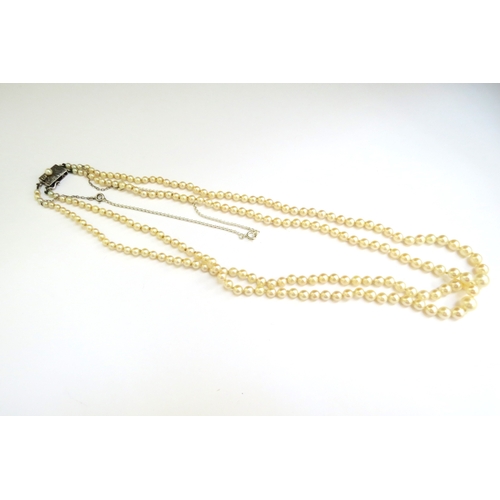 9243 - A double strand of pearls with silver clasp, 50cm long  (R)  £100